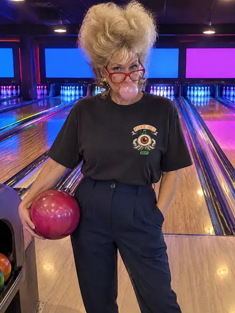 Deborah from HR wearing H13 Please Hold Tee.